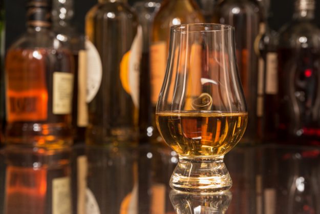 Whiskey Tasting in Wien – Glas vor Flaschen